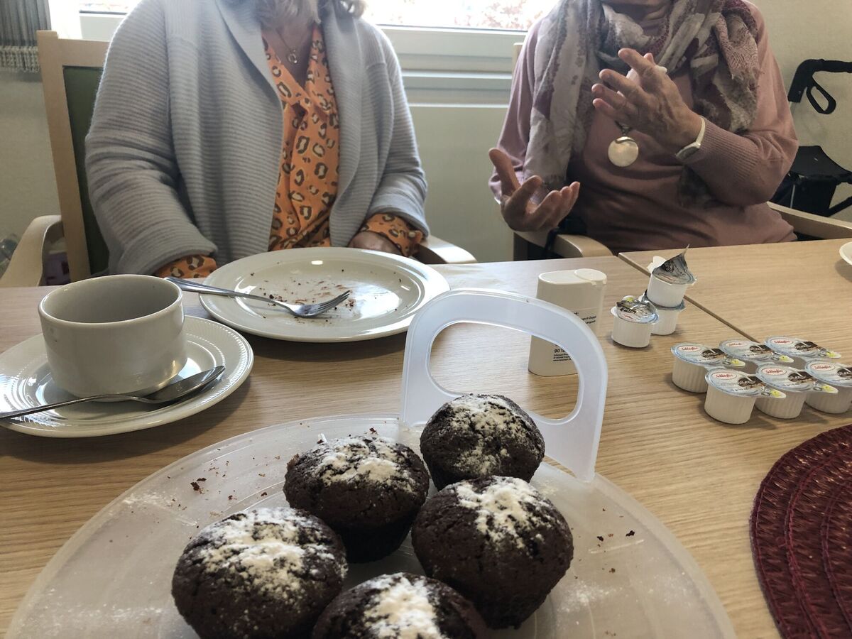 Zwei Personen im Gespräch und Kuchen